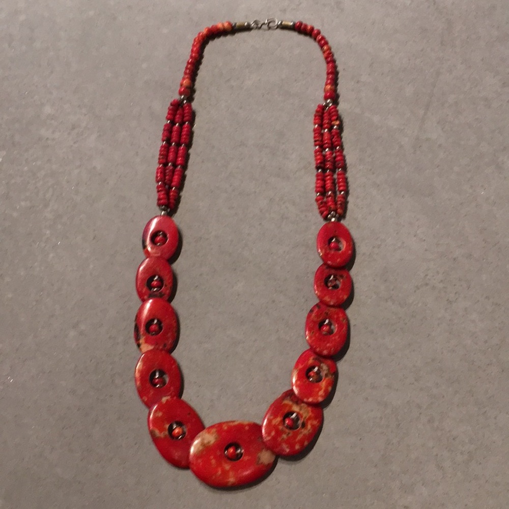 Red coral colored statement necklace.